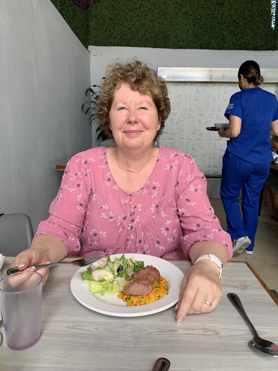 Shauna LeBlanc smiling at a table during her recovery journey in Mexico